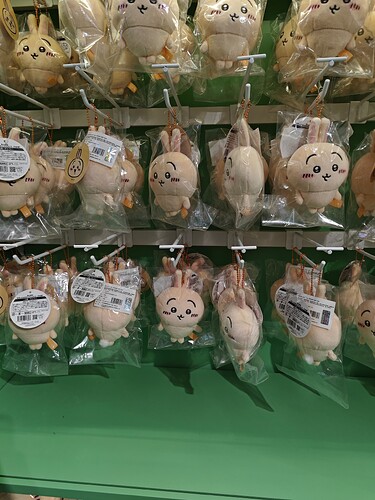 The image shows multiple plush toys, individually wrapped in clear plastic bags, hanging from a display. (由 AI 生成标题)
